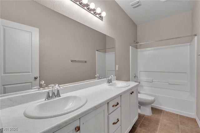 full bathroom with toilet, double vanity, a sink, and shower / bathtub combination