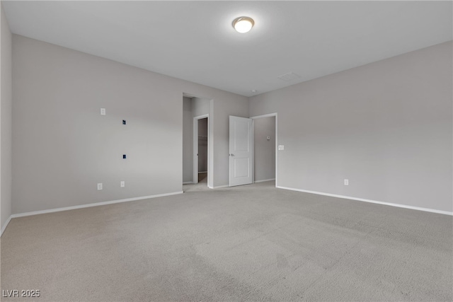 carpeted spare room with baseboards