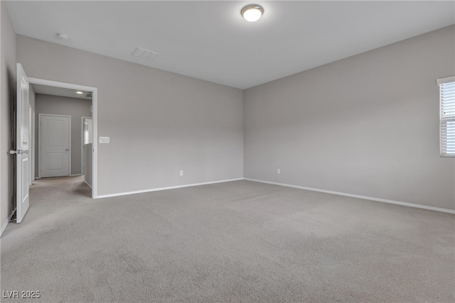 unfurnished room with carpet floors and baseboards