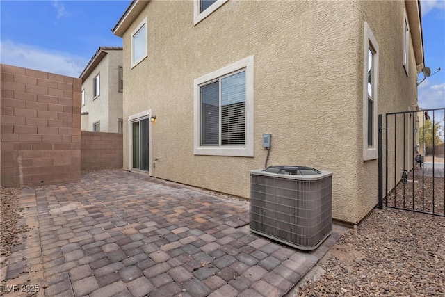 back of property featuring a patio area, stucco siding, and central AC unit