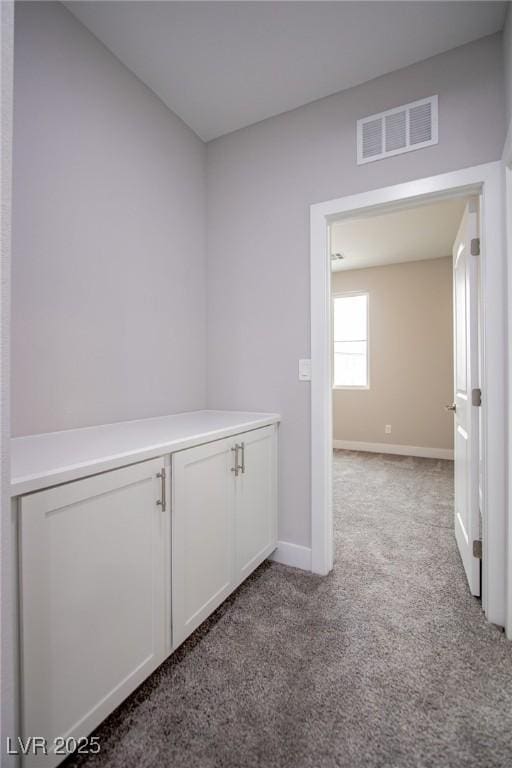 hallway with light colored carpet