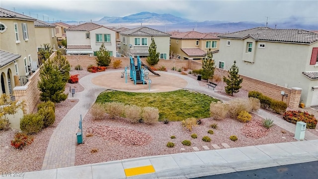 exterior space featuring a playground and a mountain view