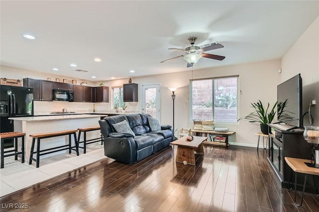 living room with hardwood / wood-style flooring, a wealth of natural light, and ceiling fan