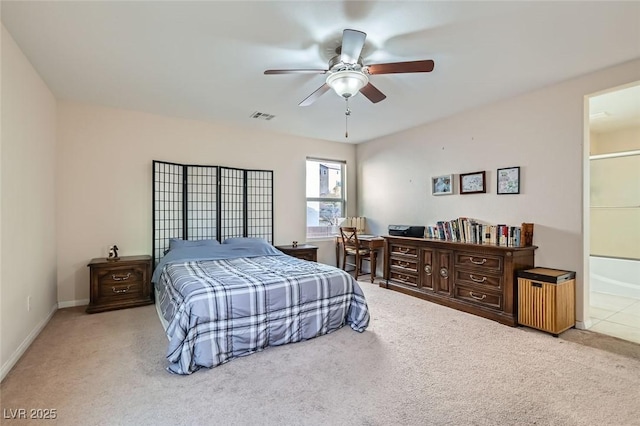 bedroom featuring ceiling fan, connected bathroom, and light carpet