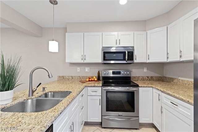 kitchen with pendant lighting, sink, white cabinetry, and stainless steel appliances