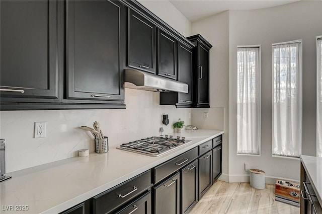 kitchen with light hardwood / wood-style flooring and stainless steel gas stovetop