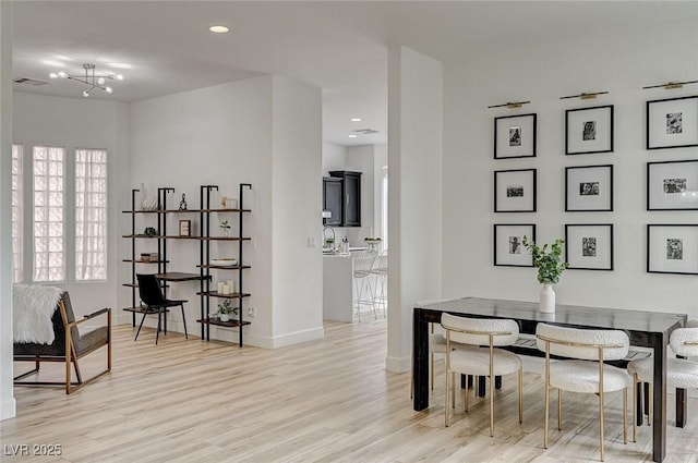 dining room with a wealth of natural light and light wood-type flooring