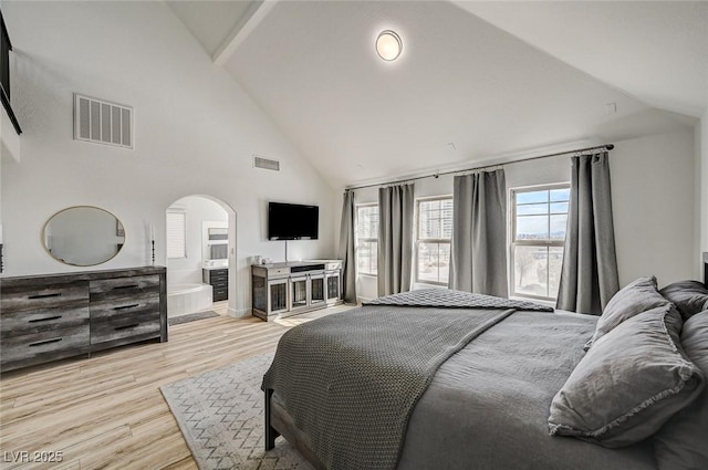 bedroom featuring light hardwood / wood-style flooring and high vaulted ceiling