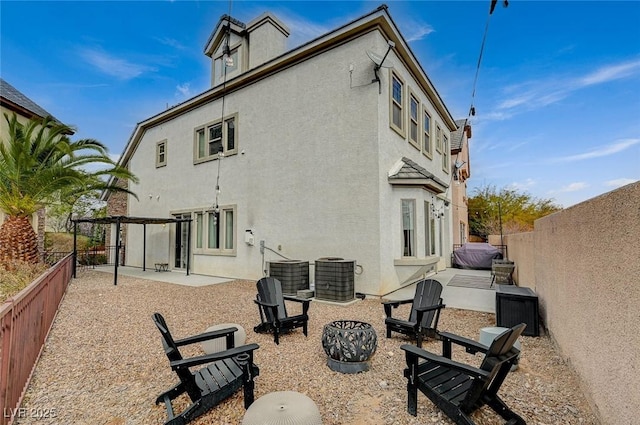 rear view of house with central AC unit and a patio