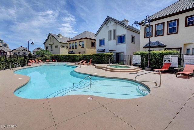 view of pool featuring a community hot tub and a patio area