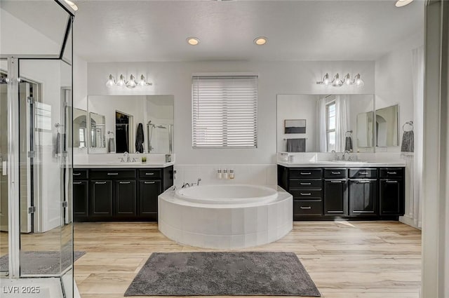 bathroom with vanity and separate shower and tub