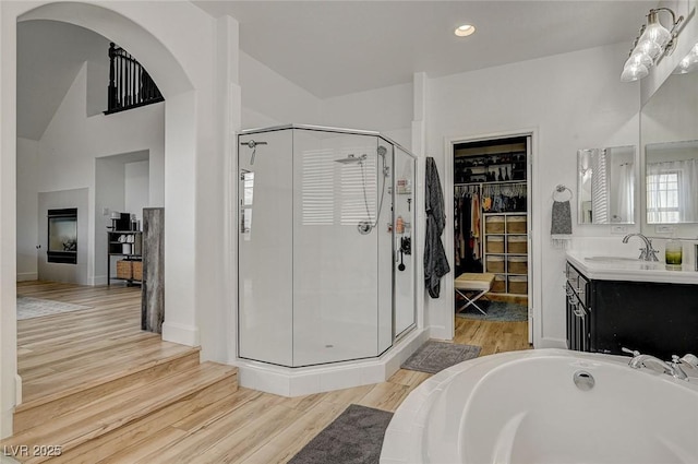 bathroom featuring independent shower and bath, vanity, and hardwood / wood-style flooring