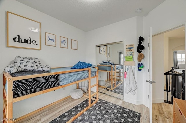 bedroom with wood-type flooring and a closet