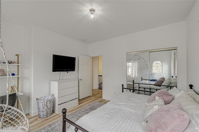 bedroom featuring light hardwood / wood-style floors and a closet