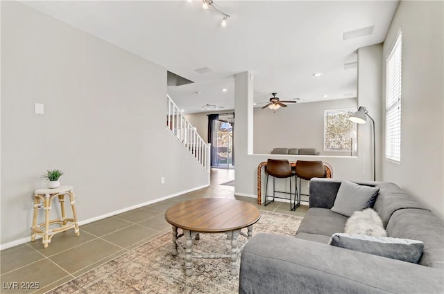 tiled living room with ceiling fan