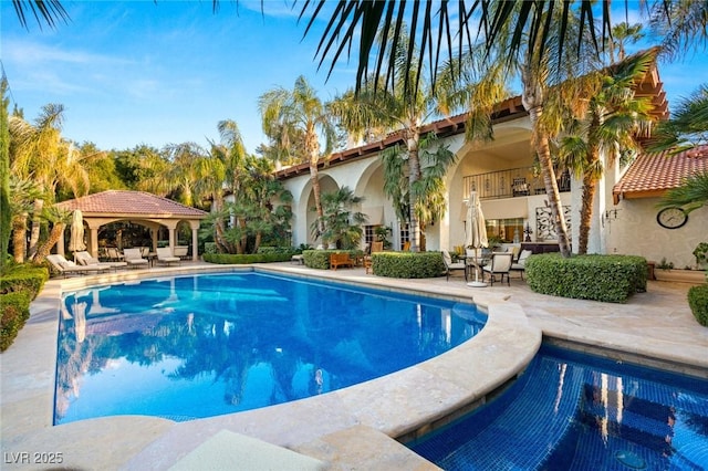 view of swimming pool with a gazebo and a patio area