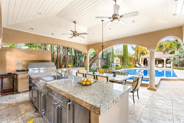 view of patio featuring a bar, a grill, area for grilling, ceiling fan, and a gazebo