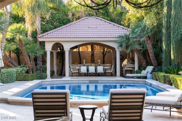 view of swimming pool featuring an outdoor structure and a patio