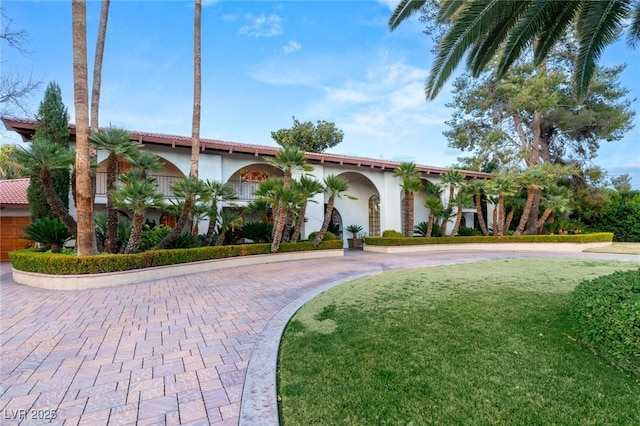 mediterranean / spanish house with a front yard