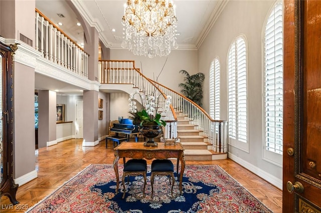 entrance foyer featuring crown molding, a wealth of natural light, and light parquet floors