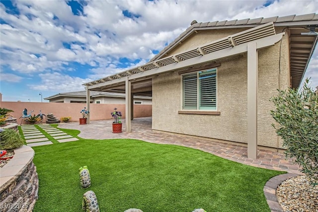 back of property featuring a patio and a yard