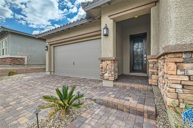 view of exterior entry featuring a garage