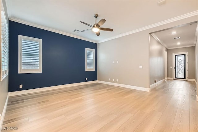 empty room featuring crown molding, light wood-type flooring, and ceiling fan