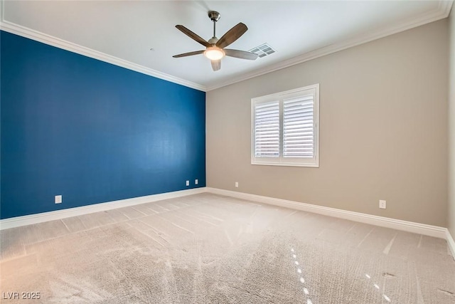 carpeted spare room featuring ornamental molding and ceiling fan