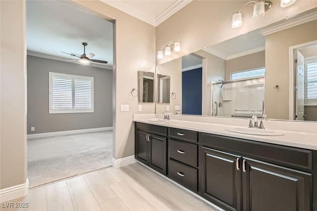 bathroom featuring hardwood / wood-style floors, ornamental molding, a shower with door, and a healthy amount of sunlight