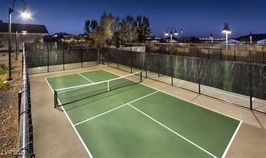 view of tennis court featuring basketball hoop