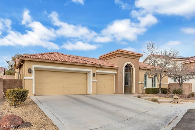 mediterranean / spanish-style house featuring an attached garage, a tile roof, concrete driveway, and stucco siding