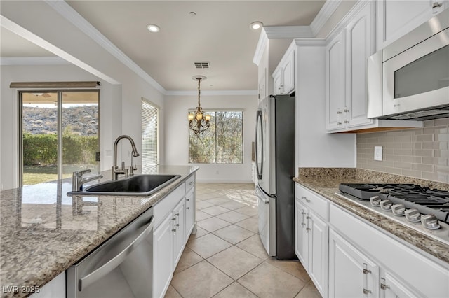 kitchen featuring sink, light tile patterned floors, stainless steel appliances, light stone countertops, and white cabinets