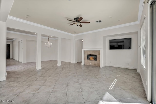 unfurnished living room with a tile fireplace, ceiling fan with notable chandelier, crown molding, and light tile patterned floors