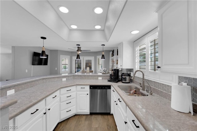 kitchen featuring white cabinetry, plenty of natural light, stainless steel dishwasher, and dark hardwood / wood-style floors