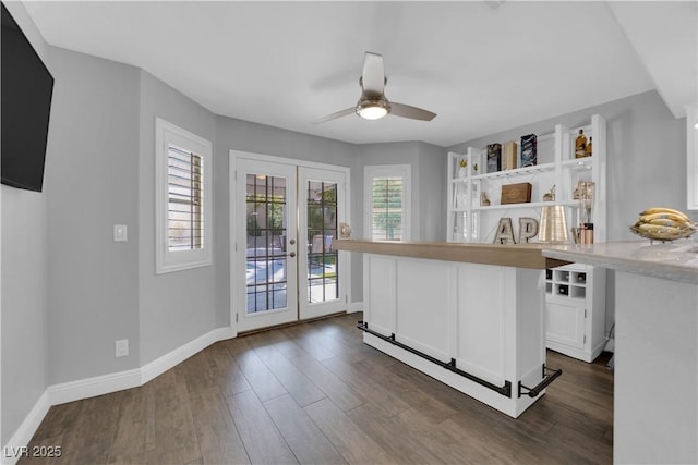 kitchen with dark hardwood / wood-style flooring, ceiling fan, french doors, and white cabinets