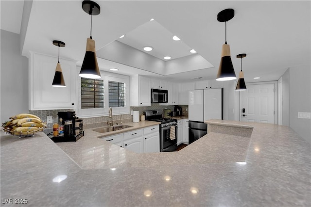 kitchen featuring sink, decorative backsplash, white cabinets, and appliances with stainless steel finishes