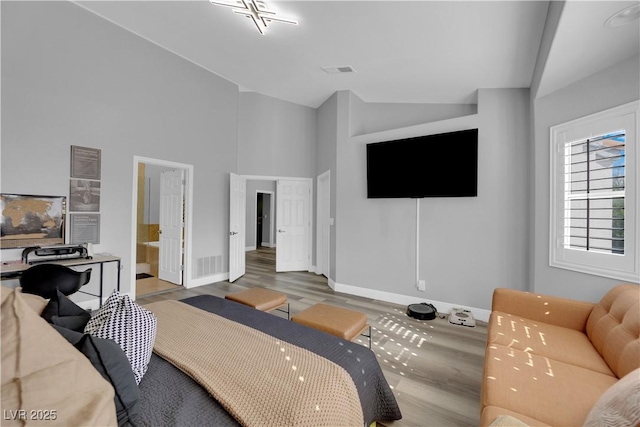 living room featuring high vaulted ceiling and light wood-type flooring