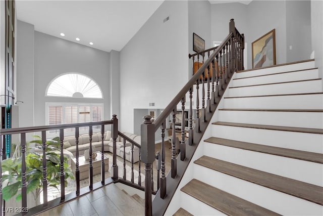 staircase with a high ceiling