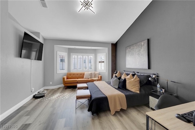 living room with lofted ceiling and light wood-type flooring