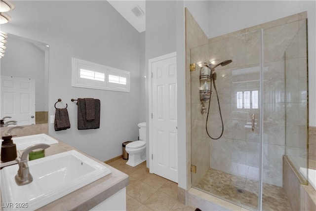 bathroom featuring vaulted ceiling, an enclosed shower, tile patterned floors, and toilet