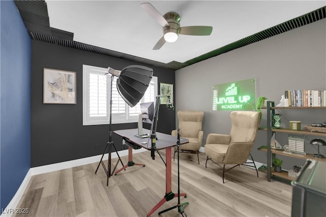 office with light hardwood / wood-style floors and ceiling fan