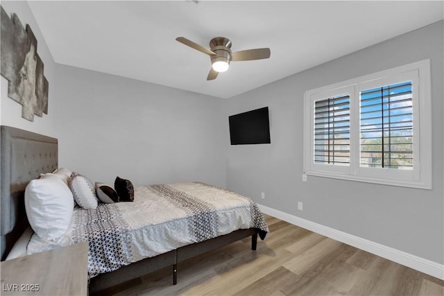 bedroom with ceiling fan and light hardwood / wood-style floors