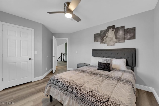 bedroom with ceiling fan and light wood-type flooring