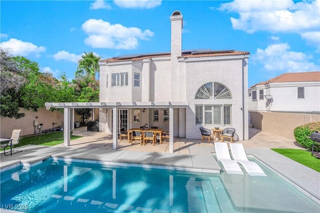 rear view of property with a patio and a pergola