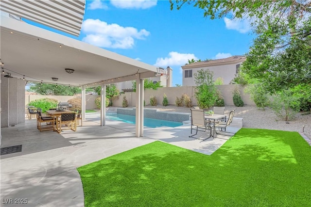 view of swimming pool with a yard and a patio area