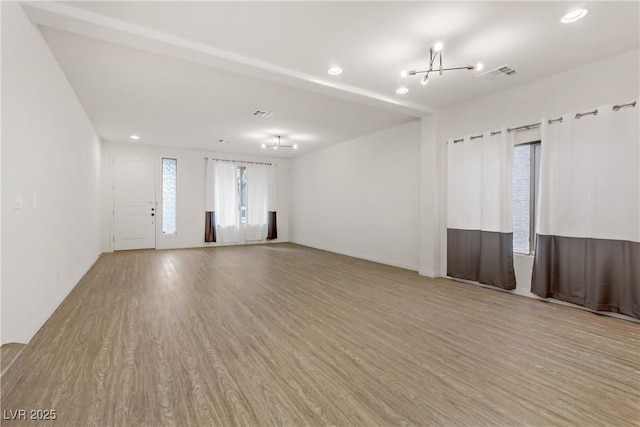 empty room featuring plenty of natural light and light wood-type flooring