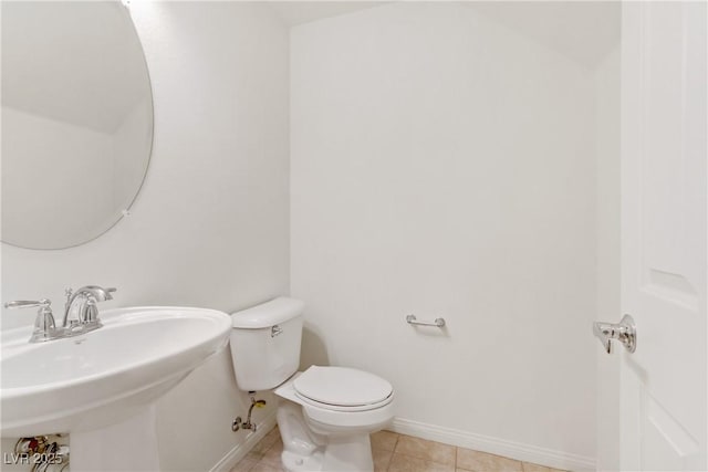 bathroom with sink, toilet, and tile patterned flooring