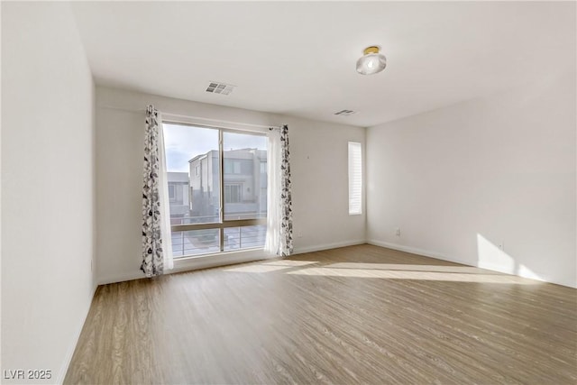 unfurnished room featuring light hardwood / wood-style floors