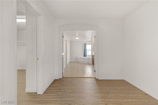 corridor with light wood-type flooring