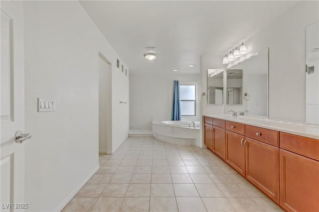 bathroom with tile patterned flooring, vanity, and a bathtub